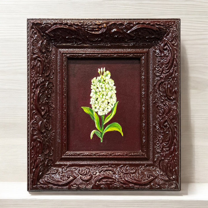 Deep red baroque frame with painted flowers.