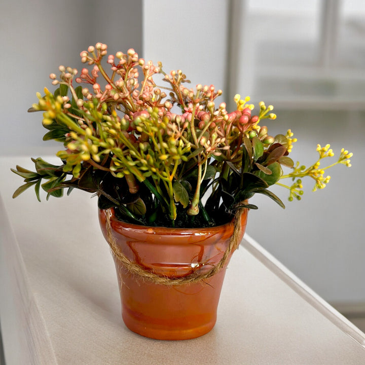 handmade ceramic planter with arrangement.